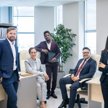 Large group of young successful intercultural white collar workers in open space office